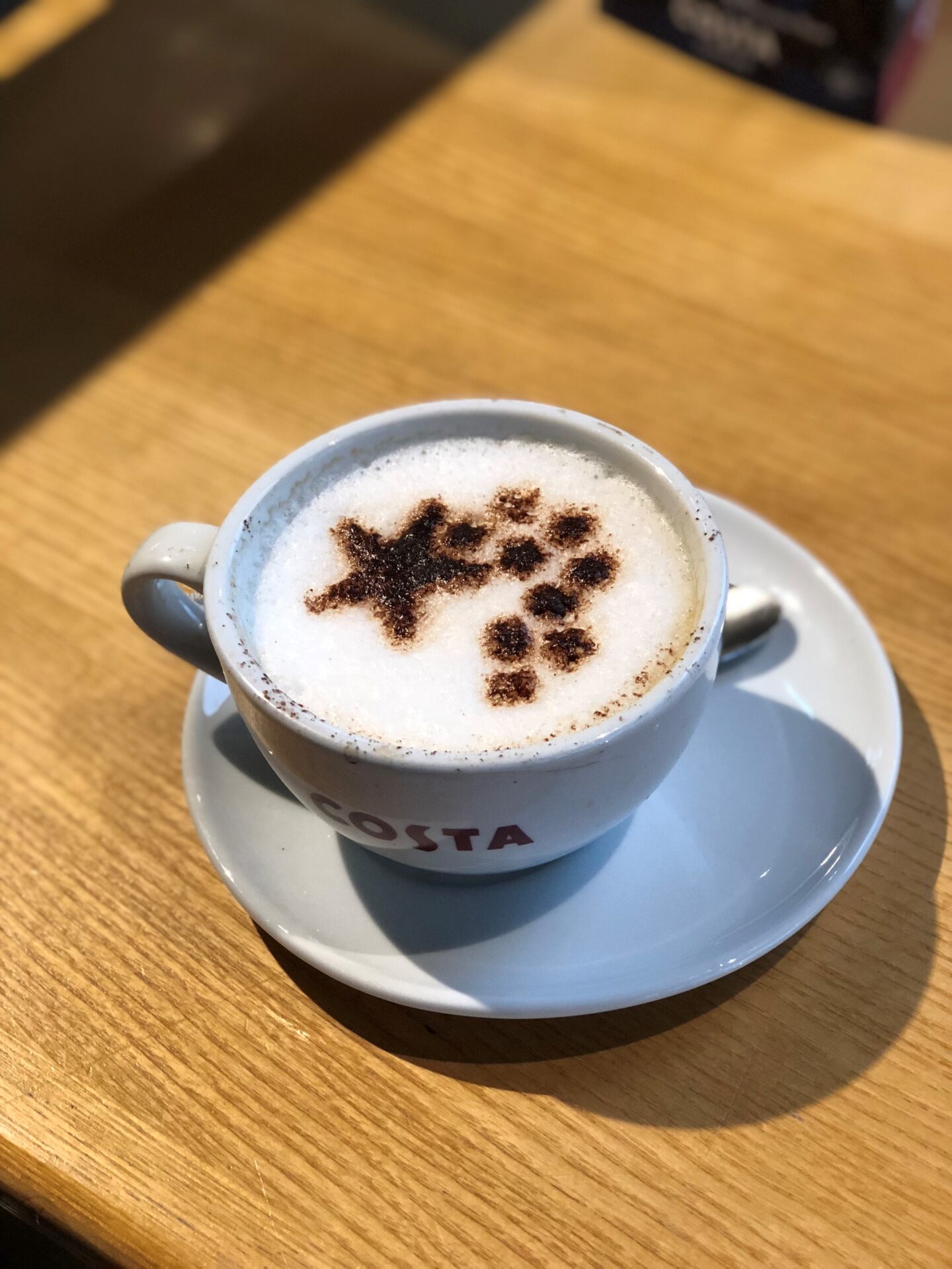 Costa Caramel Cappuccino with a festive chocolate sprinkle star